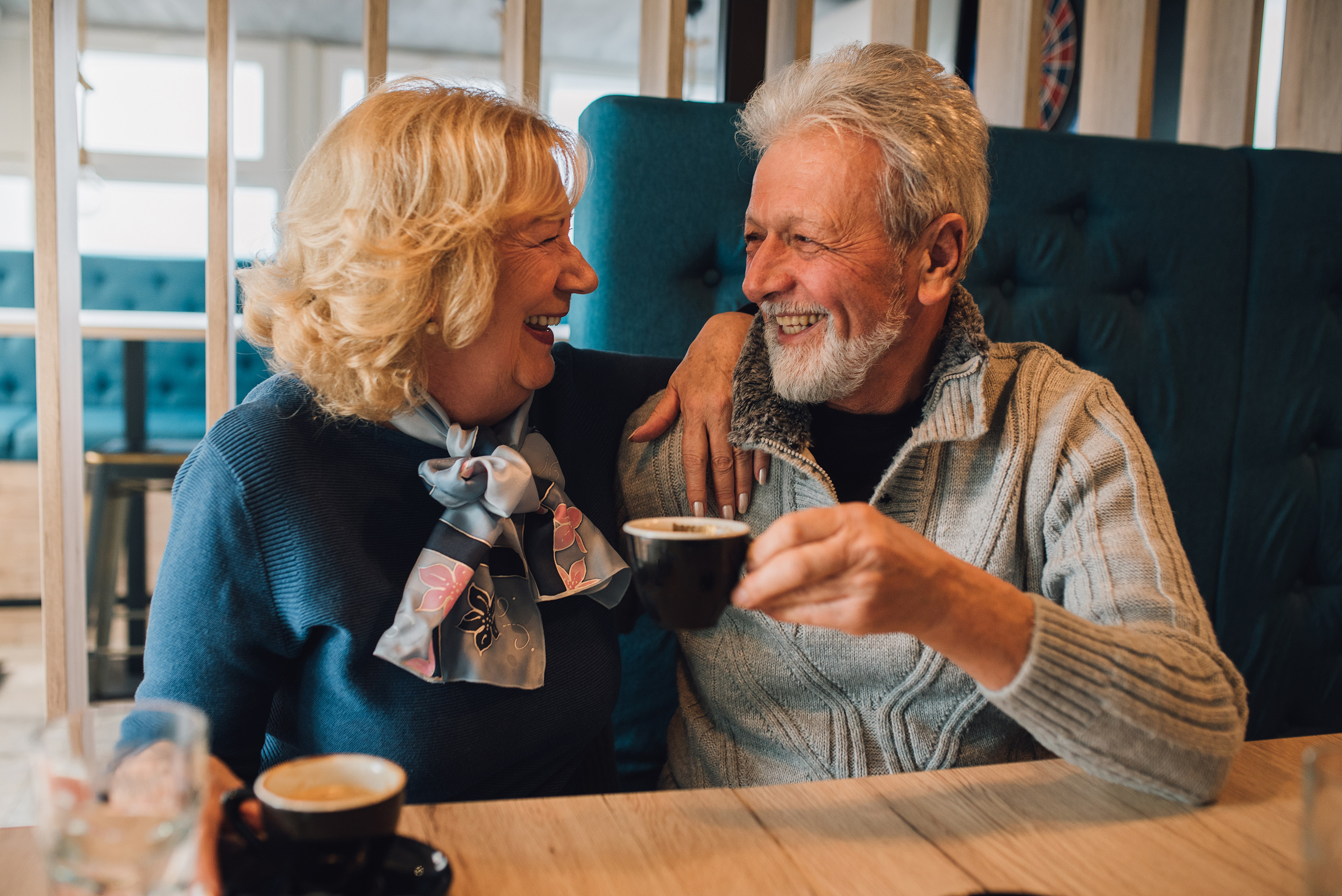 Senior couple drinking coffee and smiling